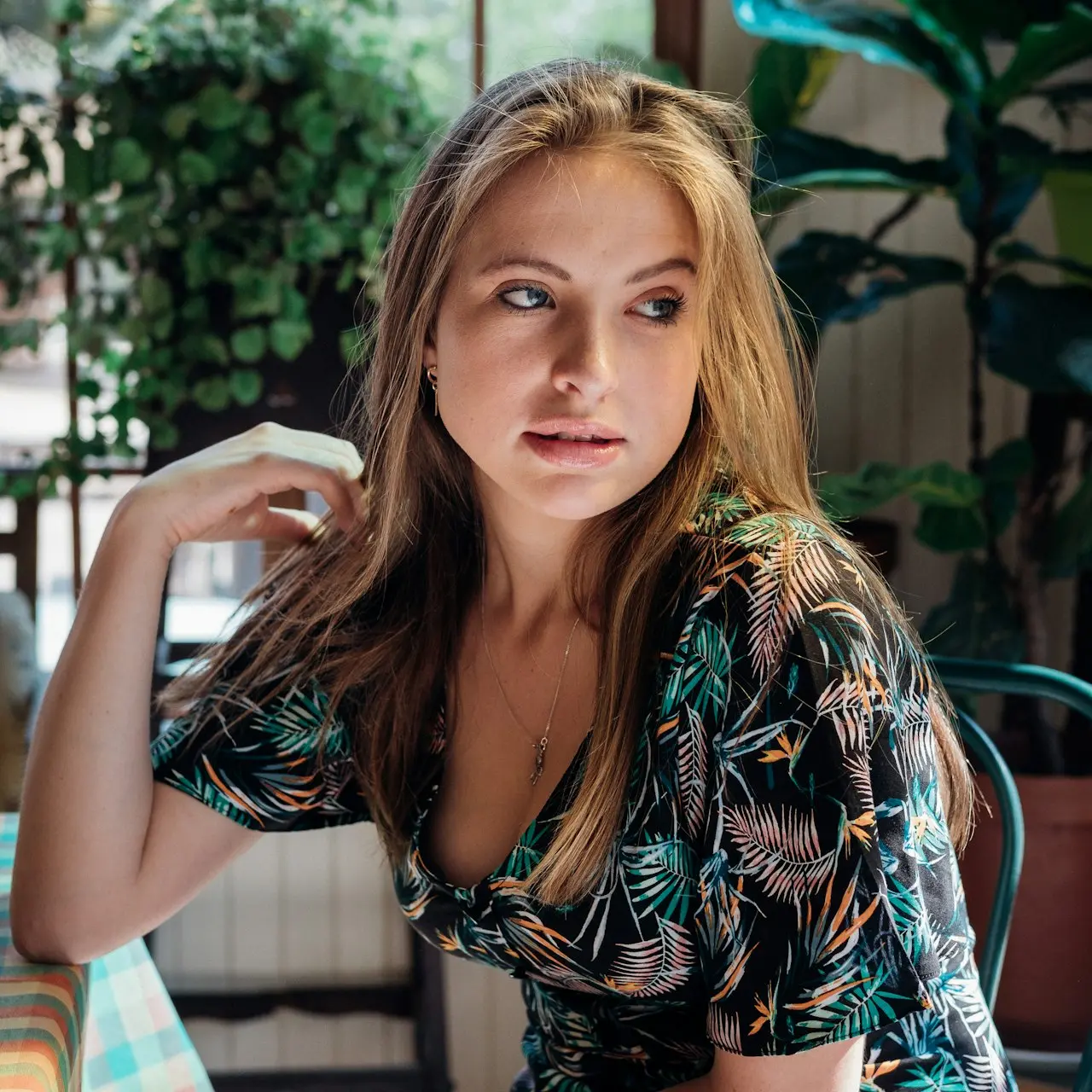 woman wearing black and blue floral scoop-neck short-sleeved dress